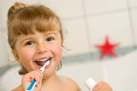 Happy Little Girl Brushing Her Teeth